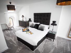 A bedroom with a bed and a window at Stunning 3 Bed Converted Village Hall Near Kelso Nenthorn near Kelso