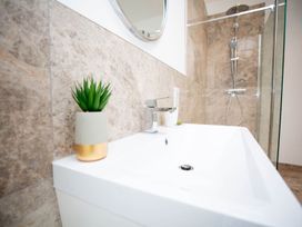 A bathroom with a bathtub and shower at Stunning 3 Bed Converted Village Hall Near Kelso