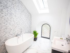 A bathroom with a bathtub and sink at Stunning 3 Bed Converted Village Hall Near Kelso Nenthorn near Kelso