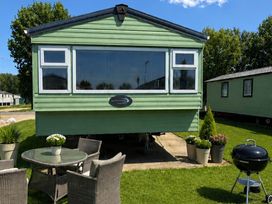 A caravan with outdoor seating at Billing Aquadrome Holiday Park 2bed Caravan Northampton