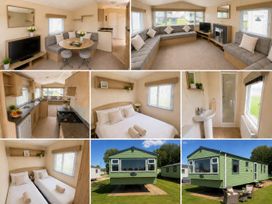 A living room with a sofa and television at Billing Aquadrome Holiday Park 2bed Caravan Northampton