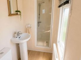 A bathroom with a sink, shower, and toilet at Billing Aquadrome Holiday Park 2bed Caravan Northampton