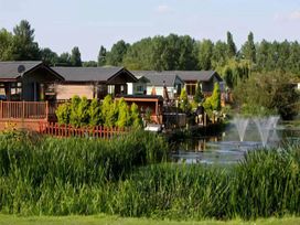 A view of cabins by the water at Billing Aquadrome Holiday Park 2bed Caravan Northampton