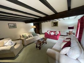 A living room with sofas and a table at The Old Barn in Manchester