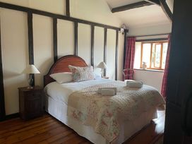 A bedroom with a bed and window at The Old Barn in Manchester