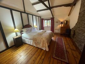 A bedroom with a bed and nightstand at The Old Barn in Manchester