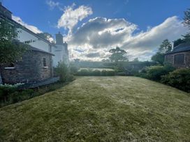 A garden with grass and trees at a property in an outdoor setting