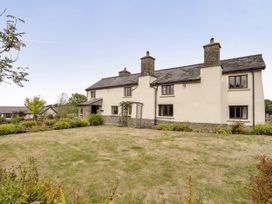 A house with windows and garden at 16th Century Devon Farmhouse Stunning Views in Winkleigh