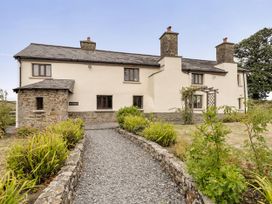 A house with a pathway and garden at 16th Century Devon Farmhouse Stunning Views Winkleigh