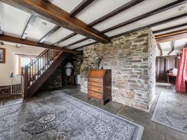 A hallway with a staircase and chest of drawers at 16th Century Devon Farmhouse Stunning Views in Winkleigh