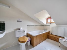 A bathroom with a bath tub, toilet, and wash basin at 16th Century Devon Farmhouse Stunning Views, Winkleigh