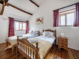 A bedroom with two beds and windows at 16th Century Devon Farmhouse Stunning Views Winkleigh