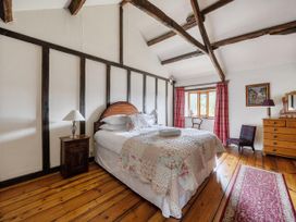 A bedroom with a bed and nightstand at 16th Century Devon Farmhouse Stunning Views in Winkleigh