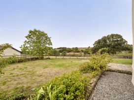 A garden with grass and a tree at 16th Century Devon Farmhouse Stunning Views, Winkleigh
