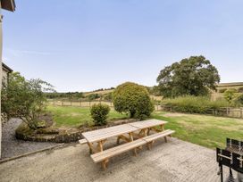 A garden with a table and benches at 16th Century Devon Farmhouse Stunning Views, Winkleigh