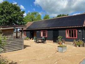 An outdoor area with a building featuring solar panels at Pet Friendly 3Bed Barn Sleeps 7 Parking Garden Westhall near Halesworth