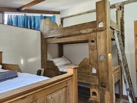 A bedroom with a bunk bed and a single bed at Pet Friendly 3Bed Barn Sleeps 7 Parking Garden Westhall near Halesworth
