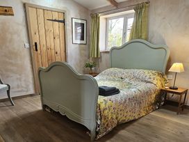 A bedroom with a bed and bedside table at Pet Friendly 3Bed Barn Sleeps 7 Parking Garden Westhall near Halesworth