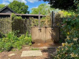 An outdoor shower in a garden at Pet Friendly 3Bed Barn Sleeps 7 Parking Garden Westhall near Halesworth