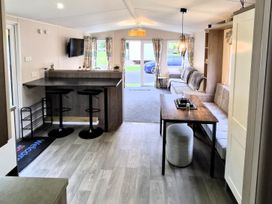 A living room with a breakfast bar and sofa at Homely Caravan in Skegness