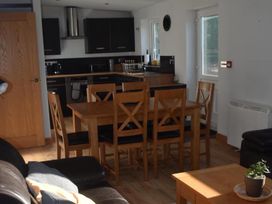 A dining area with a table and chairs at Pet friendly Cabin Sleeps 6 with Parking and Garden in Penygroes