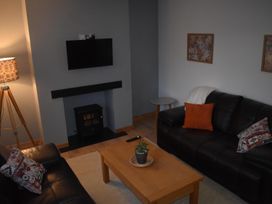 A living room with a coffee table and television at Pet friendly Cabin Sleeps 6 with Parking and Garden in Penygroes