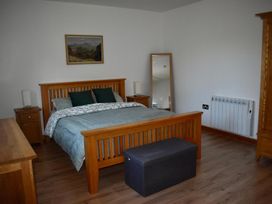 A bedroom with a bed and nightstand at Pet friendly Cabin Sleeps 6 with Parking and Garden Penygroes