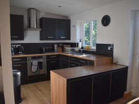 A kitchen with cabinets and countertop at Pet friendly Cabin Sleeps 6 with Parking and Garden in Penygroes