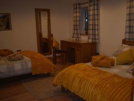 A bedroom with two beds and a desk at Pet friendly Cabin Sleeps 6 with Parking and Garden in Penygroes