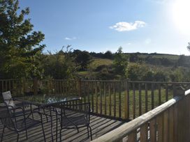 An outdoor area with a table and chairs at Pet friendly Cabin Sleeps 6 with Parking and Garden Penygroes