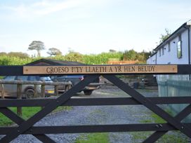 A gate with a sign at Yr Hen Beudy Barn Conversion Sleeps 4 Dogs Ok near Brodle Farm near Llansteffan
