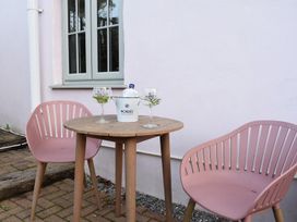 A table with chairs and drinks at Yr Hen Beudy Barn Conversion Sleeps 4 Dogs Ok in Broadle Farm near Llansteffan