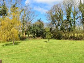 An outdoor area with trees and grass at Yr Hen Beudy Barn Conversion Sleeps 4 Dogs Ok, Brodle Farm near Llansteffan