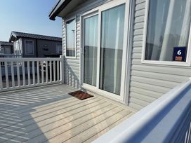 A deck with a door and window at 3Bed Sleeps 6 Parking Balcony Flamingo Land Resort near Kirkby Misperton