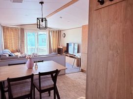 A living room with a dining area and a television at 3Bed Sleeps 6 Parking Balcony Flamingo Land Resort near Kirkby Misperton