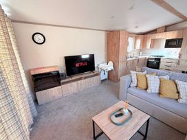 A living room with a television and sofa at 3Bed Sleeps 6 Parking Balcony Flamingo Land Resort near Kirkby Misperton