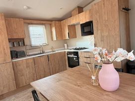 A kitchen with cabinets and appliances at 3Bed Sleeps 6 Parking Balcony in Flamingo Land Resort near Kirkby Misperton