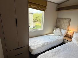 A bedroom with two beds and a window at 3Bed Sleeps 6 Parking Balcony Flamingo Land Resort near Kirkby Misperton