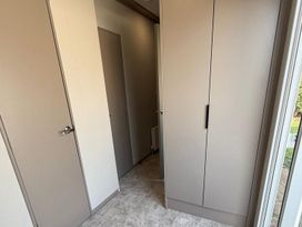 A hallway with doors and a closet at 3Bed Sleeps 6 Parking Balcony Flamingo Land Resort near Kirkby Misperton