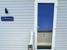 An exterior view of a door with a nameplate at Stonewood at Flamingo Land Resort near Kirkby Misperton