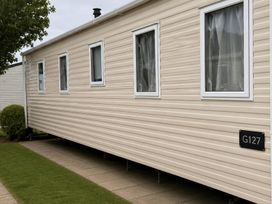 A mobile home with multiple windows at G127