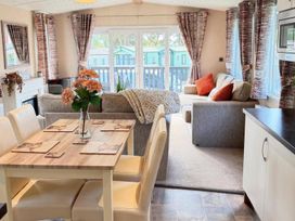 A living room with table and chairs at Lillardsedge Luxury Caravan Sleeps 6 with Parking near Lilliardsedge Holiday Park