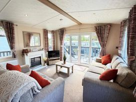 A living room with a sofa and coffee table at Lillardsedge Luxury Caravan Sleeps 6 with Parking, Lilliardsedge Holiday Park near St Boswells