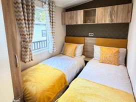 A bedroom with two beds and window at Lillardsedge Luxury Caravan Sleeps 6 with Parking near Lilliardsedge Holiday Park