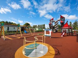 A playground with swings and climbing structures at Lillardsedge Luxury Caravan Sleeps 6 with Parking near Lilliardsedge Holiday Park