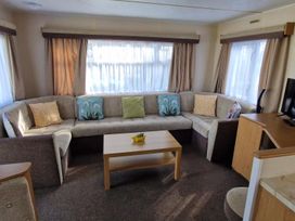 A living room with a sofa and coffee table at Woodland View Dog Friendly Nr Sutton on Sea Thurlby near Alford