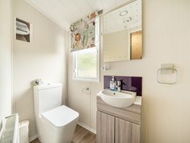A bathroom with a toilet and sink at The Old Barn in Tunstall, North Yorkshire