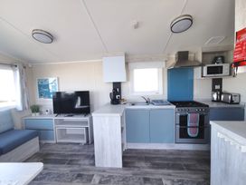 A kitchen with a stove and television at '' in ''