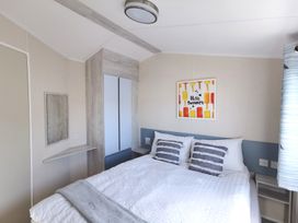 A bedroom with a bed and artwork on the wall at The Old Barn in Manchester