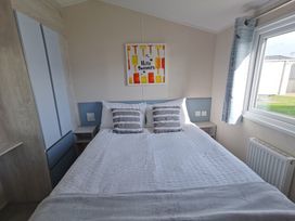 A bedroom with a bed and wall art at a property